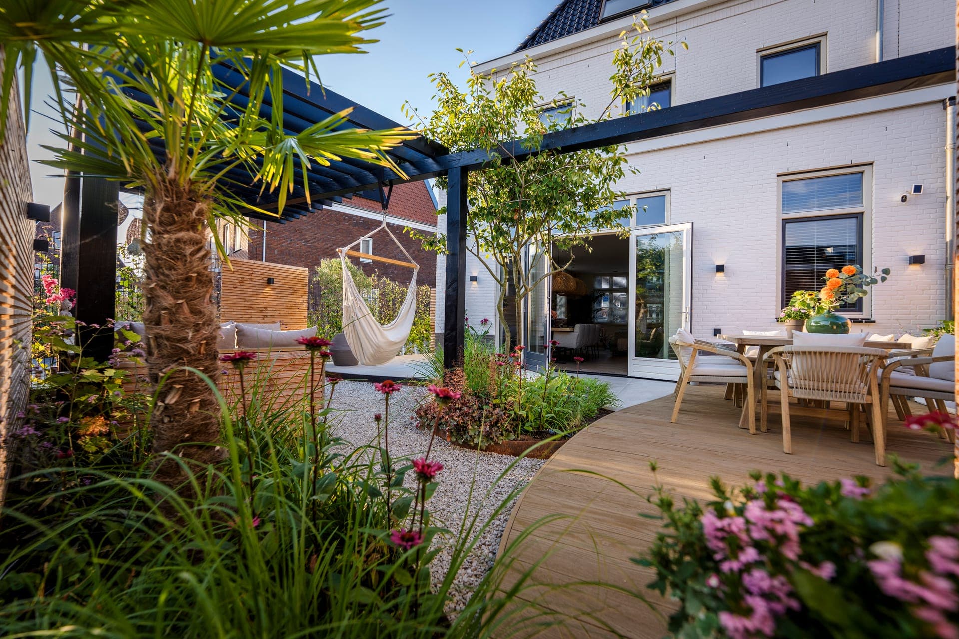 Totaaloverzicht met eettafel, palmboom en pergola