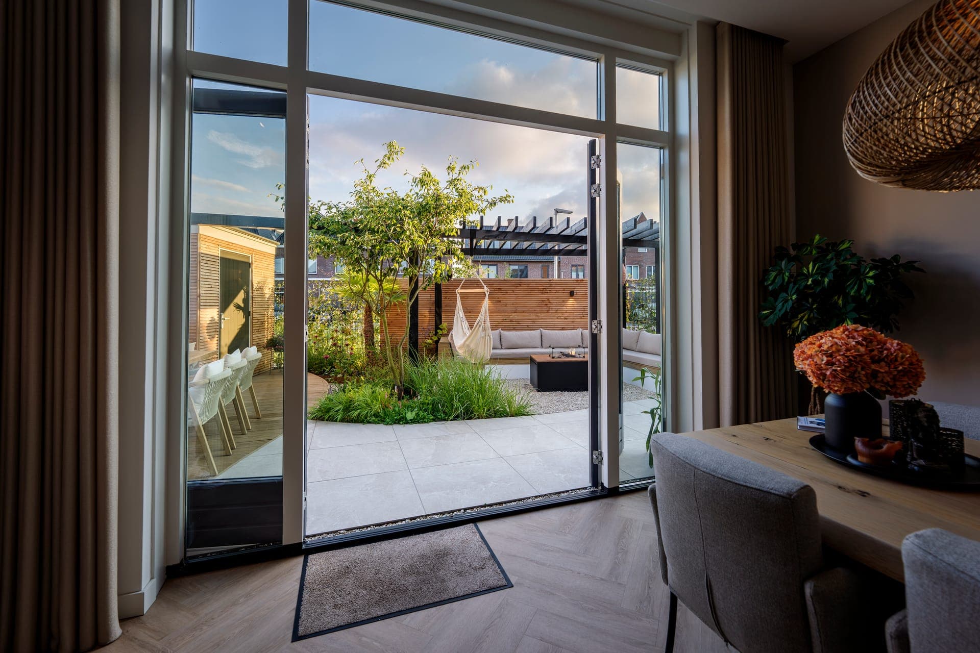 Zicht vanuit de woonkamer op terras en lounge